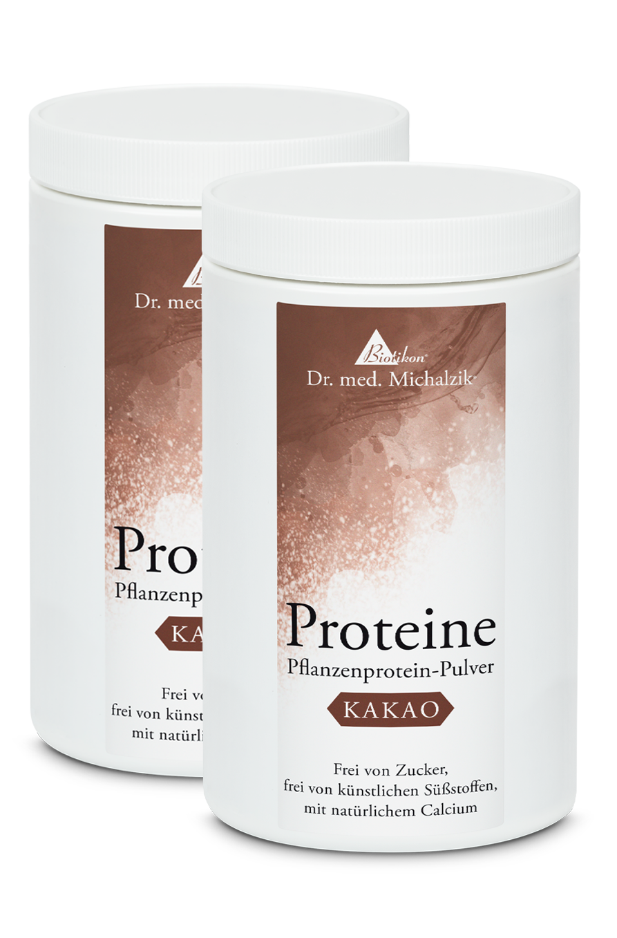 Plant Protein Powder Cocoa – 500 g Two white containers of plant protein powder cocoa, 500 g, on a white background.